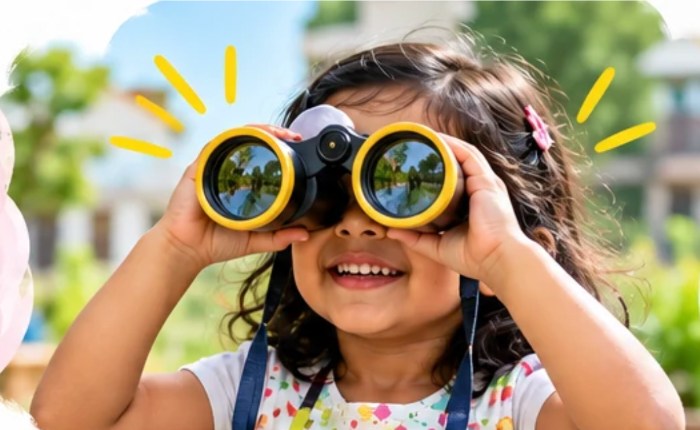Child discovering the world through binoculars